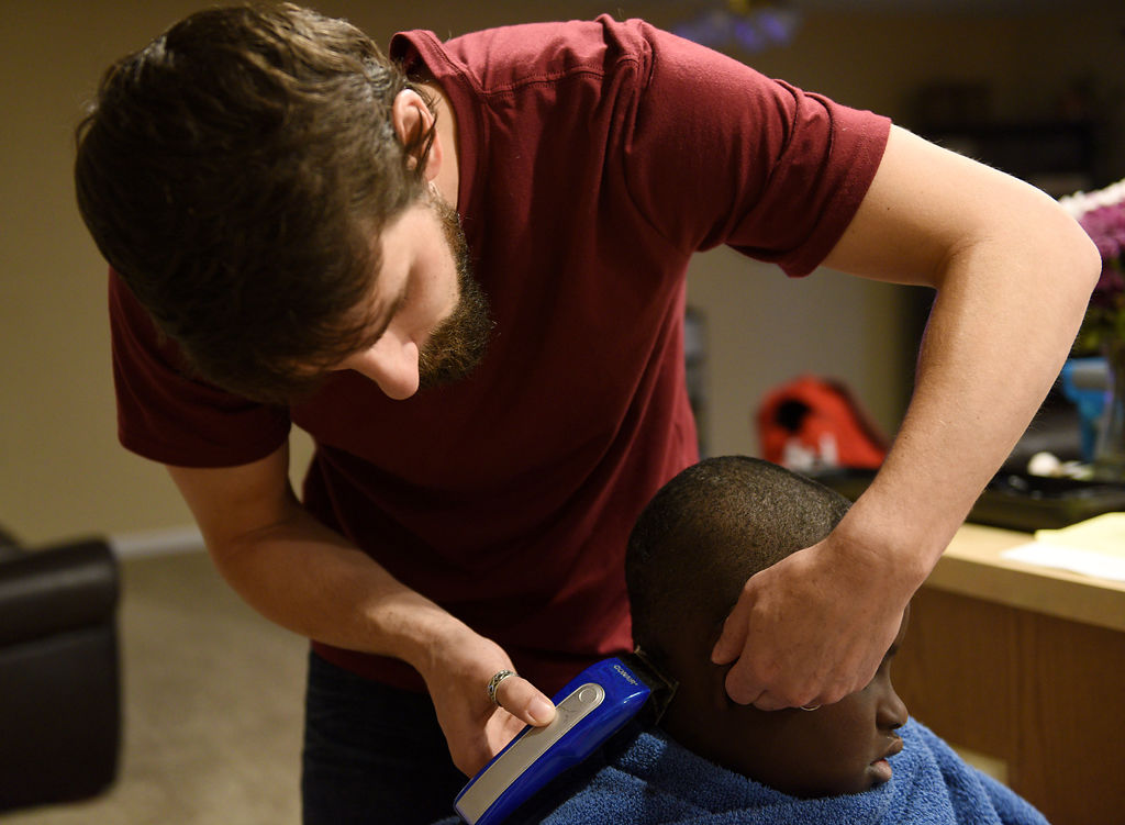 Jordan Douce gives a resident a haircut